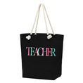 Load image into Gallery viewer, Black tote bag with 'TEACHER' in colorful letters and rope handles on a white background, and inside zipper! bagNook.com
