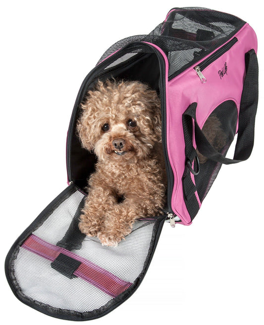 Small dog inside a pink and black pet carrier on a white background